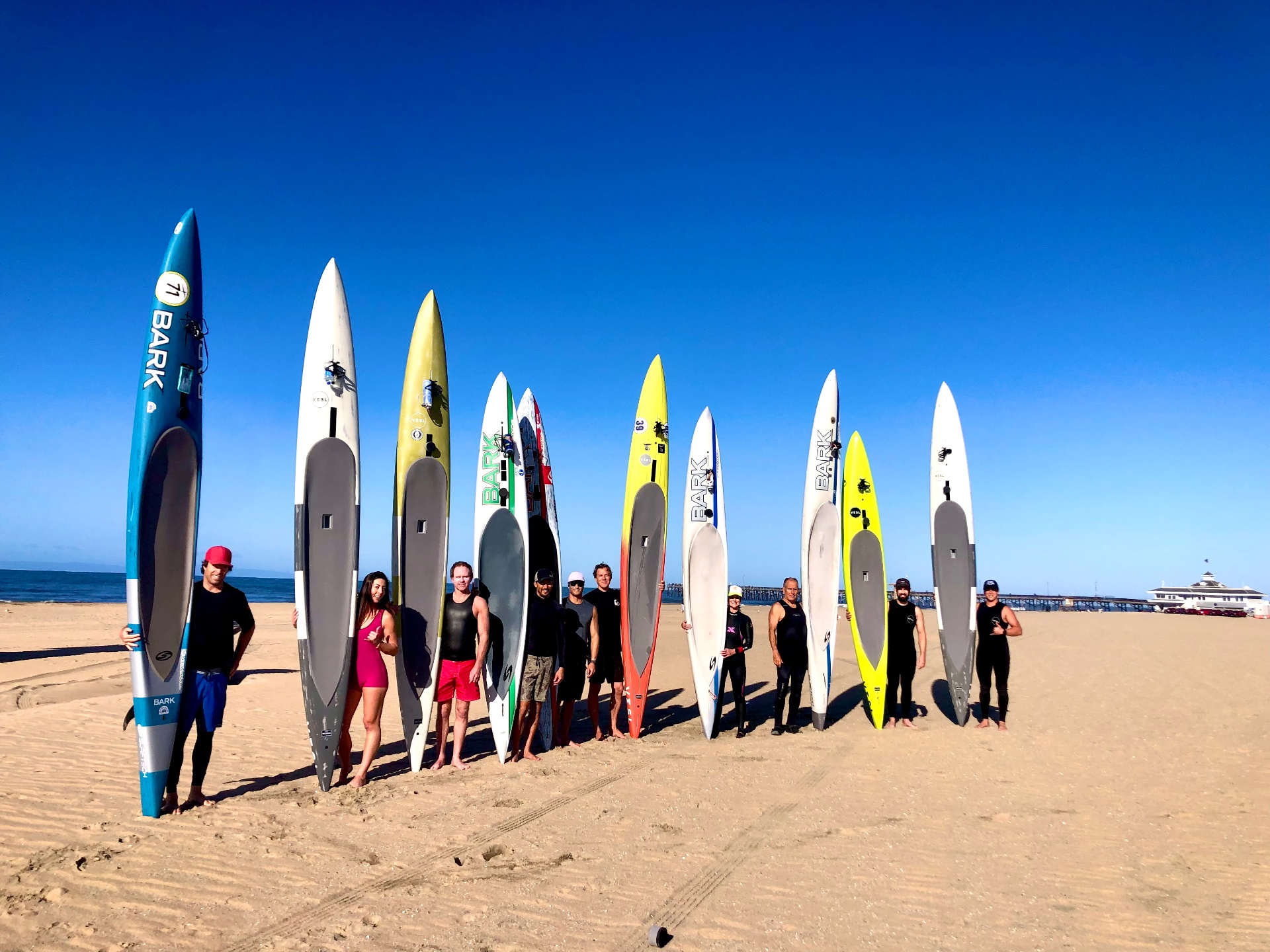 Paddleboard group lined up on the beach